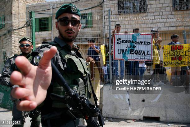 Israeli border police stand guard during a demonstration organised by young Palestinians in Hebron on September 3 against a recent decision by Israel...