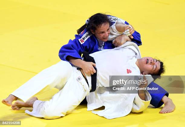 Brazil's Maria Portela competes with Russia's Alana Prokopenko during their -70kg match of the team event at the World Judo Championships in Budapest...