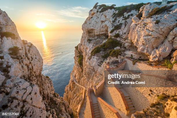 capo caccia, alghero, sardinia. the incredible staircase of neptuno grotto at sunset - alghero stock pictures, royalty-free photos & images