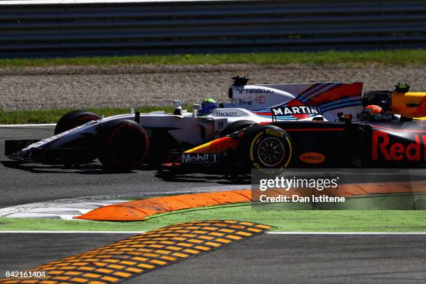 Max Verstappen of the Netherlands driving the Red Bull Racing Red Bull-TAG Heuer RB13 TAG Heuer and Felipe Massa of Brazil driving the Williams...