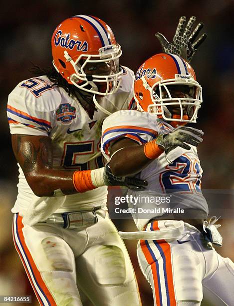 Jermaine Cunningham of the Florida Gators celebrates his interception with teammate Brandon Spikes against the Oklahoma Sooners in the FedEx BCS...