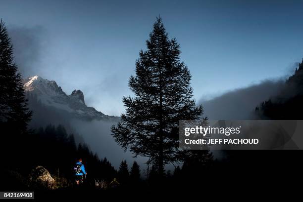 An Ultra-trailer competes in Le Col des Montets on September 3, 2017 near Chamonix, during the 15th edition of the Mount Blanc Ultra Trail , a 170 km...