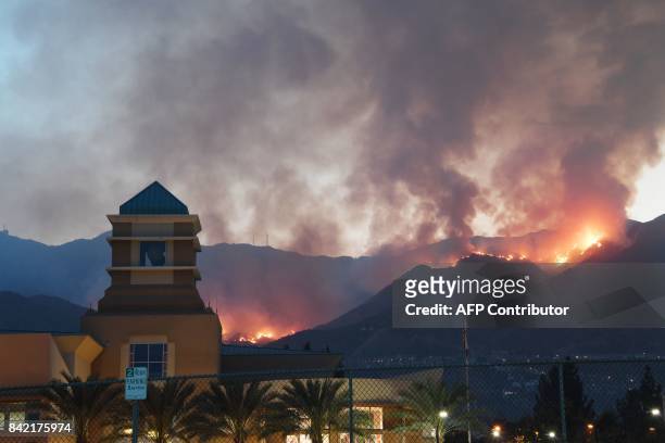 The La Tuna fire burns above downtown Burbank, California, onSeptember 3, 2017. More than 5,000 acres have burned in the intense brush fire forcing...