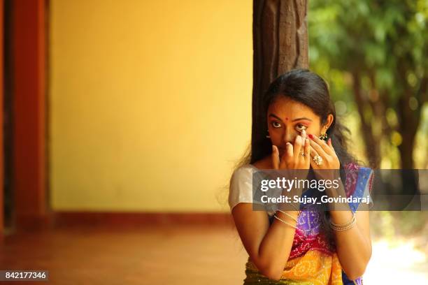 indian female applying kajal - kajal stock pictures, royalty-free photos & images