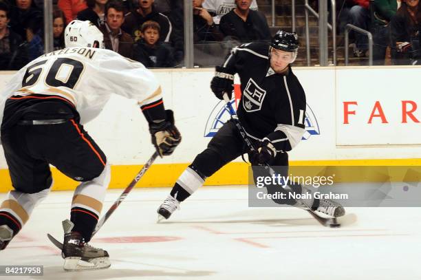 Brendan Mikkelson of the Anaheim Ducks defends against Patrick O'Sullivan of the Los Angeles Kings during the game on January 8, 2009 at Staples...