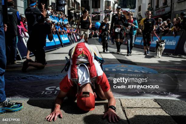 An ultra-trailer reacts after crossing the finish line of the 15th edition of the Mount Blanc Ultra Trail , a 170 km race around the Mont Blanc...