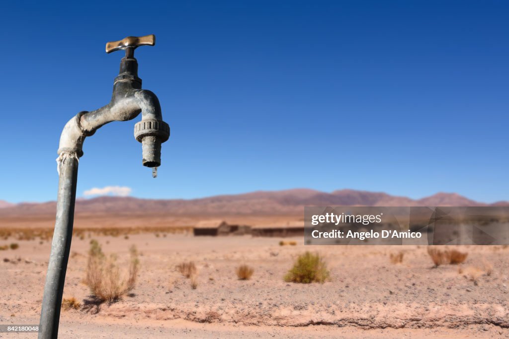 Drips faucet and dry environment in the background