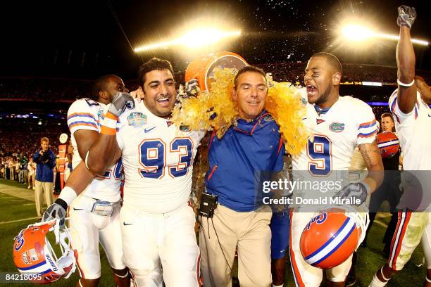 Head coach Urban Meyer of the Florida Gators gets gatorade dumped on him as Javier Estopinan and Louis Murphy look on towards the end of the game...