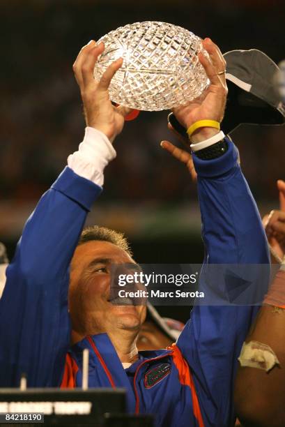 Head coach Urban Meyer of the Florida Gators celebrates with the National Championship trophy after their 24-14 win against the Oklahoma Sooners...