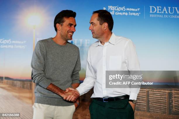 French director Alexandre Moors shakes hand with British cinematographer Daniel Landin as they poses during a photocall for the film "The Yellow...