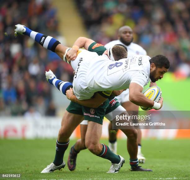Taulupe Faletau of Bath Rugby is taken off his feet by Nick Malouf of Leicester Tigers during the Aviva Premiership match between Leicester Tigers...