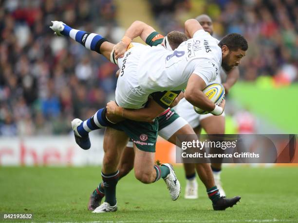 Taulupe Faletau of Bath Rugby is taken off his feet by Nick Malouf of Leicester Tigers during the Aviva Premiership match between Leicester Tigers...