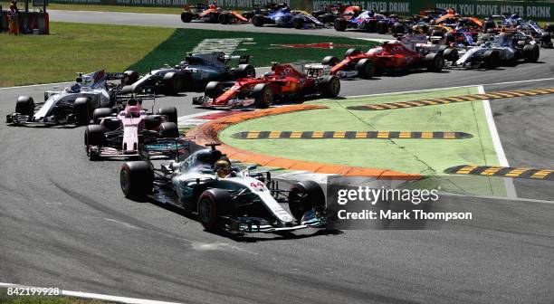 Lewis Hamilton of Great Britain driving the Mercedes AMG Petronas F1 Team Mercedes F1 WO8 leads the field at the start during the Formula One Grand...