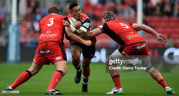 Tusi Pisi of Bristol Rugby attempts to make a break past Rupert Harden of Hartpury College and Rhys Oakley of Hartpury College during the Greene King...