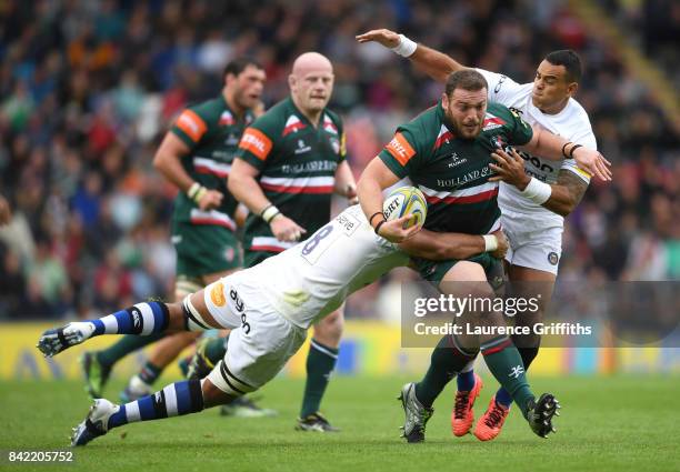 Greg Bateman of Leicester Tigers is tackled by Taulupe Faletau of Bath Rugy during the Aviva Premiership match between Leicester Tigers and Bath...