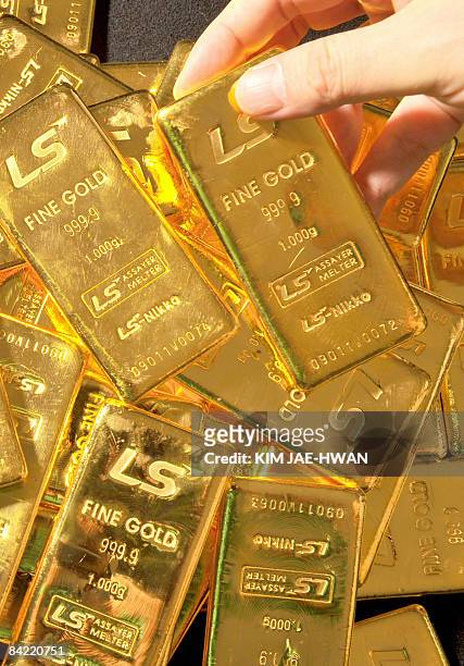 Pure 1,000-gram gold bars produced by South Korea's LS-Nikko are stacked in a dealers room in Seoul on January 9, 2009. Gold prices have soared on...