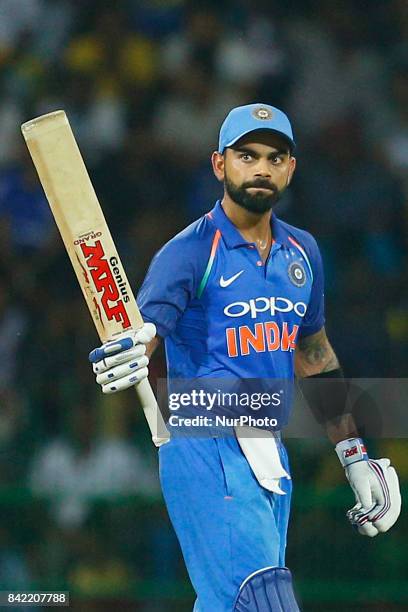 Indian cricket captain Virat Kohli raises his bat after scoring 50 runs during the 5th and final One Day International cricket match between Sri...