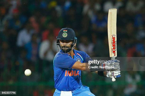 Indian cricket captain Virat Kohli looks at the ball after playing a shot during the 5th and final One Day International cricket match between Sri...