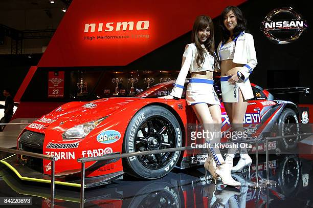 Model poses with Nissan Xanavi Nismo GT-R at a booth at Tokyo Auto Salon 2009 at Makuhari Messe on January 9, 2009 in Chiba, Japan. More than 300...