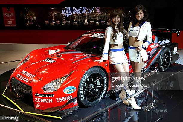 Model poses with Nissan Xanavi Nismo GT-R at a booth at Tokyo Auto Salon 2009 at Makuhari Messe on January 9, 2009 in Chiba, Japan. More than 300...