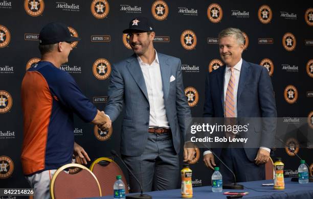 Justin Verlander , center, along with manager A.J. Hinch, left, and general manager Jeff Luhnow during a press conference to officially introduce...