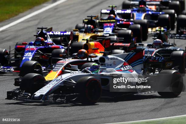 Felipe Massa of Brazil driving the Williams Martini Racing Williams FW40 Mercedes leads Max Verstappen of the Netherlands driving the Red Bull Racing...