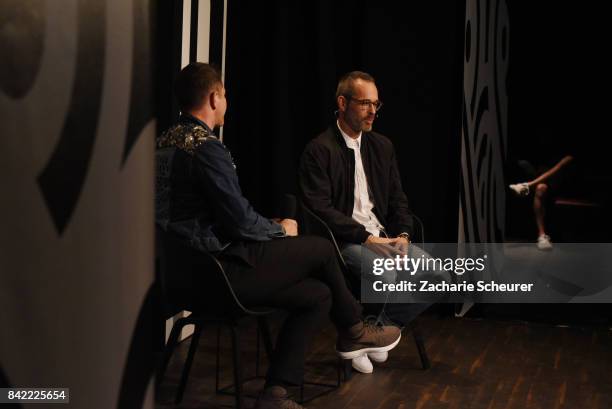 Host Thierry-Maxime Loriot and designer Viktor Horsting speak at a panel talk ahead of the 'Viktor & Rolf' fashion show during Bread & Butter by...