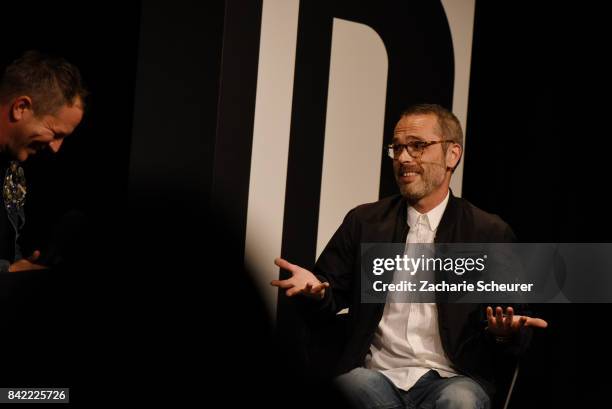 Host Thierry-Maxime Loriot and designer Viktor Horsting speak at a panel talk ahead of the 'Viktor & Rolf' fashion show during Bread & Butter by...