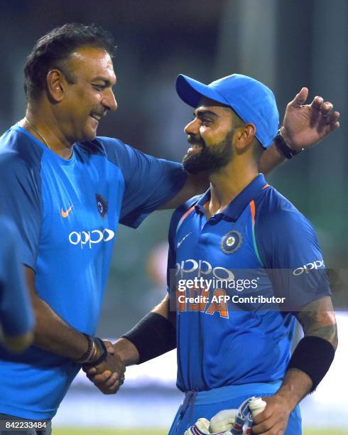 Indian cricket captain Virat Kohli celebrates with coach Ravi Shastri after victory in the final one day international cricket match between Sri...