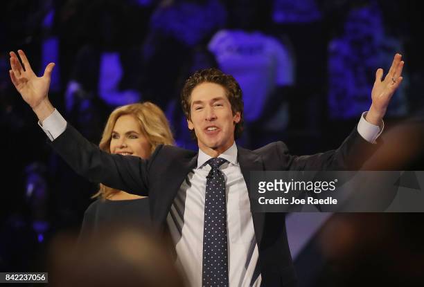 Joel Osteen, the pastor of Lakewood Church, stands with his wife, Victoria Osteen, as he conducts a service at his church as the city starts the...