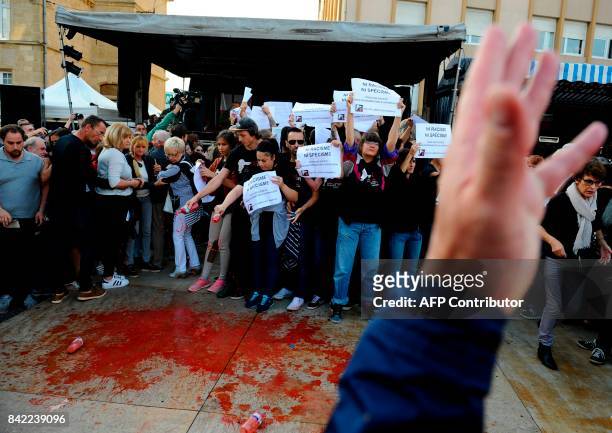 Members of the animal protection association "269 Life Liberte Animale" pour red fake blood as they demonstrate at the start of a speech by Far-right...