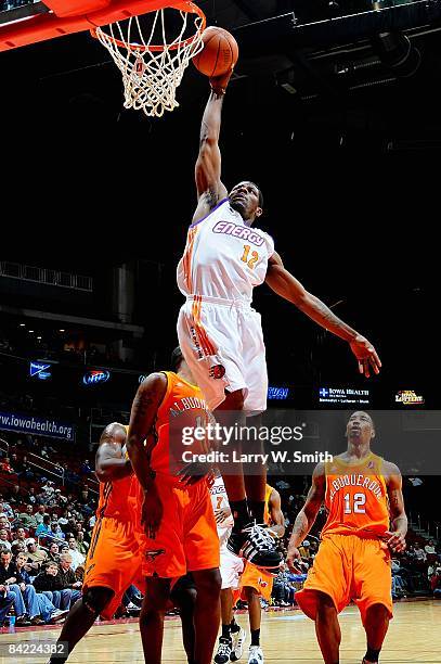 Othyus Jeffers of the Iowa Energy slam dunks over Kris Clack and Cheyne Gadson of the Albuquerque Thunderbirds during the D-League game on December...