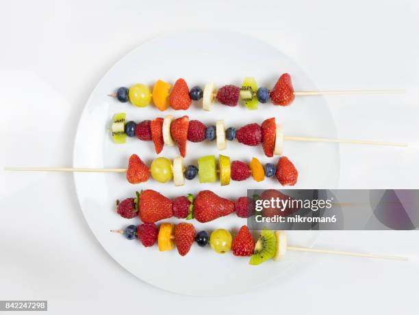 plate of mixed fruits on skewers - skewer stock pictures, royalty-free photos & images