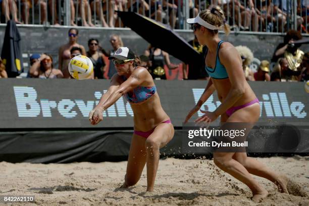 Lauren Fendrick digs the ball as teammate April Ross looks on during their match against Kelly Claes and Sara Hughes in the semifinal round at the...