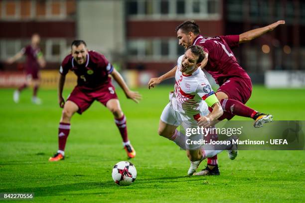 Stephan Lichtsteiner of Switzerland is fouled by Vitalijs Maksimenko of Latvia during the FIFA 2018 World Cup Qualifier between Latvia and...