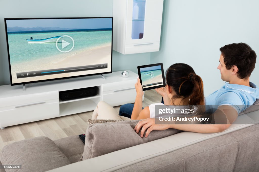 Couple Watching Movie Using Digital Tablet
