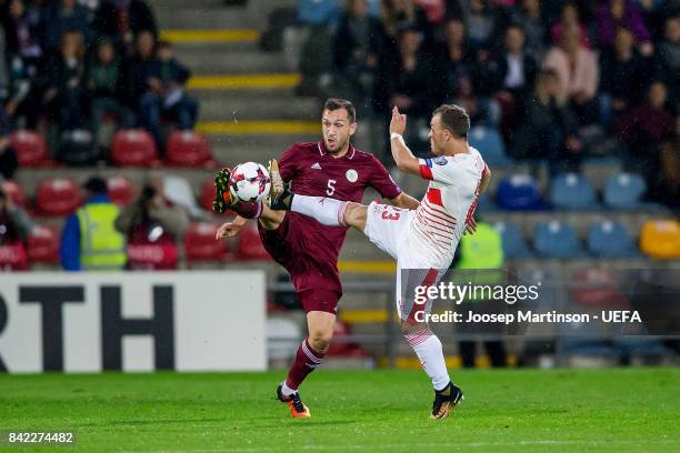 Olegs Laizans of Latvia competes with Xherdan Shaqiri of Switzerland during the FIFA 2018 World Cup Qualifier between Latvia and Switzerland at...