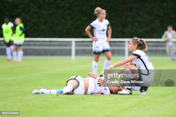 Ami Otaki of Paris FC goes down injured and is assisted by Camille Catala of Paris FC during women's Division 1 match between FC Fleury 91 and Paris...