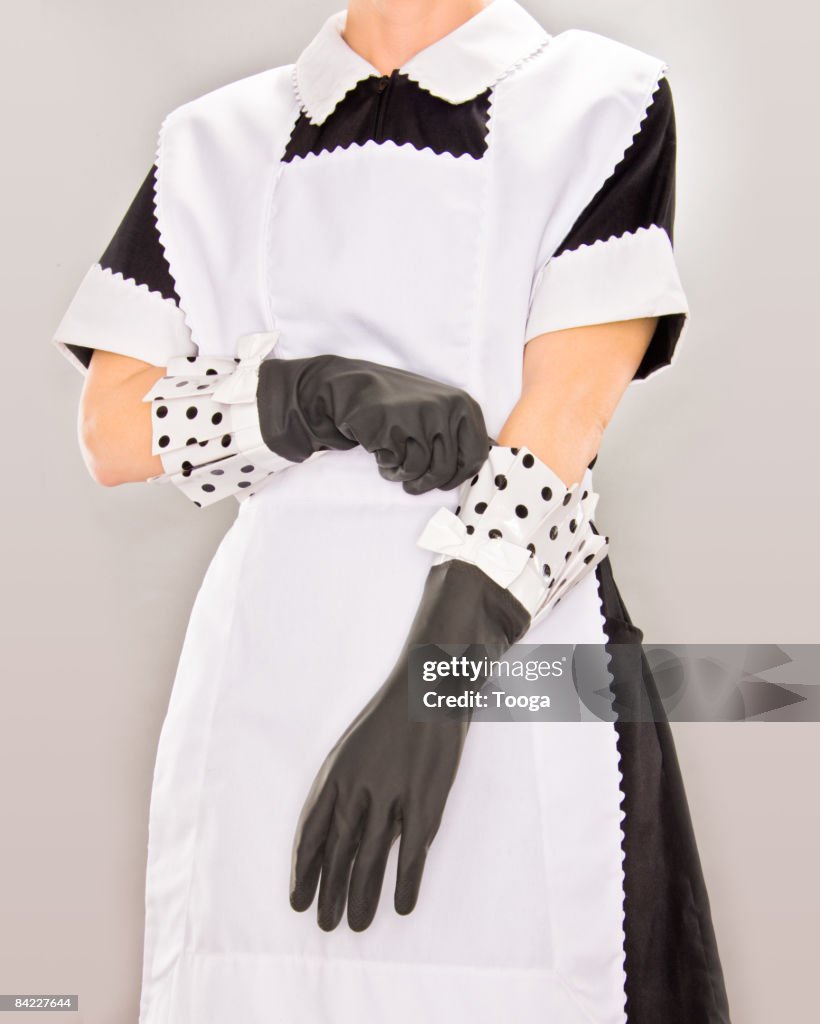 Maid putting on rubber gloves