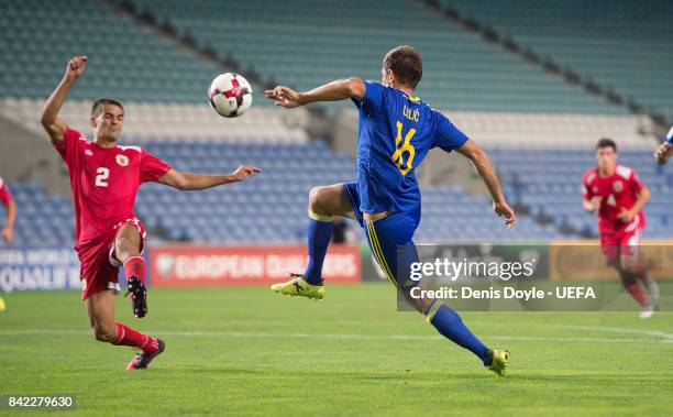 Senad Lulic of Bosnia and Herzegovina is challenged by Jean Garcia of Gibraltar during FIFA 2018 World Cup Qualifier between Gibraltar and Bosnia and...