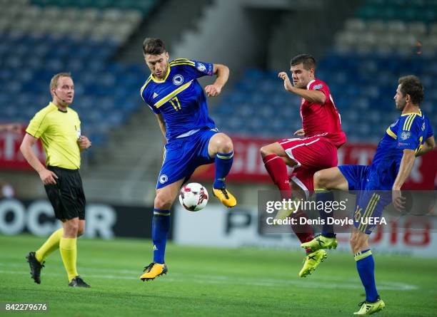 Ervin Zukanovic of Bosnia and Herzegovina controls the ball beside Liam Walker of Gibraltar during FIFA 2018 World Cup Qualifier between Gibraltar...