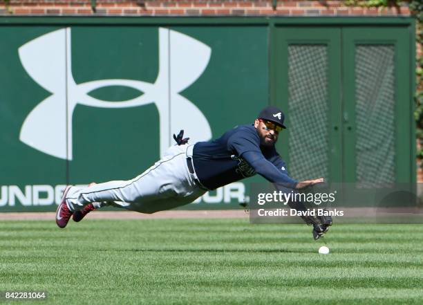 Matt Kemp of the Atlanta Braves can't make a catch on a single hit by Ian Happ of the Chicago Cubs during the fifth inning on September 3, 2017 at...