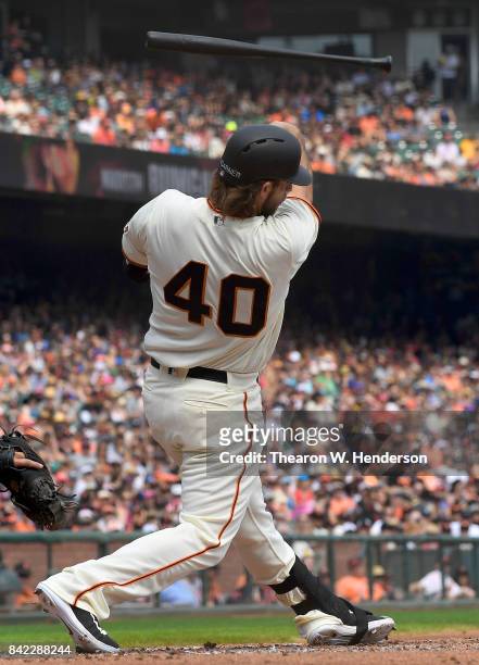 Pitcher Madison Bumgarner of the San Francisco Giants swings and loses control of his bat thowing it into the stands during the bottom of the second...