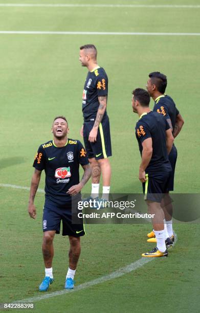 Brazil's striker Neymar laughs during a training session in Arena Amazonia, Manaus, Brazil, on September 3, 2017 ahead of their upcoming 2018 FIFA...