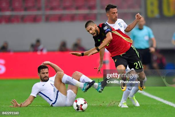 Yannick Carrasco forward of Belgium is tackled by Alexandros Tziolis midfielder of Greece during the World Cup Qualifier Group H match between Greece...