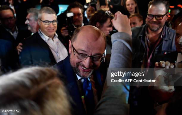 Martin Schulz, leader of Germany's social democratic SPD party and candidate for Chancellor, celebrates with SPD colleagues after a televised debate...