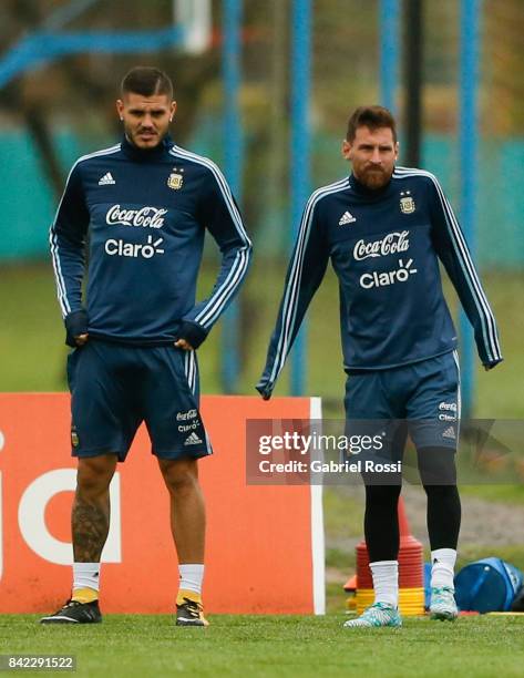 Mauro Icardi and Lionel Messi of Argentina warm up during a training session at 'Julio Humberto Grondona' training camp on September 03, 2017 in...