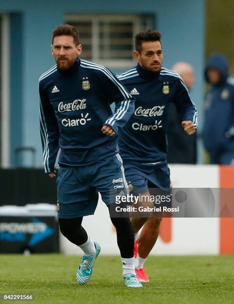 Lionel Messi and Lautaro Acosta of Argentina warm up during a training session at 'Julio Humberto Grondona' training camp on September 03, 2017 in...