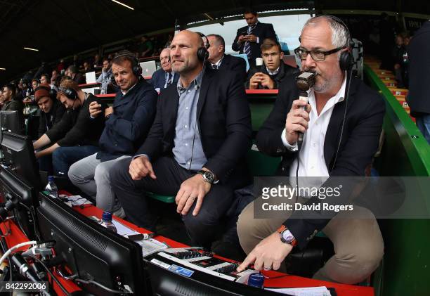 Nick Mullins, the BT Sport rugby commentator watches the match with pundits Lawrence Dallaglio and Austin Healey during the Aviva Premiership match...