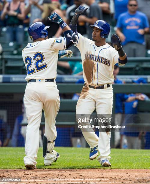 Jean Segura of the Seattle Mariners congratulates Robinson Cano of the Seattle Mariners after Cano hit a two-run home run off of starting pitcher...